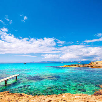 Jetty and private boats at Formentera´s most beautiful and famous beach, Playa de ses Illetes.